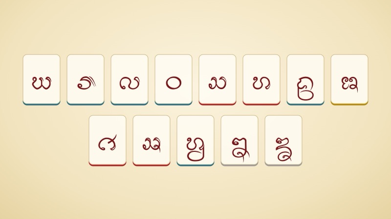 The 13 Lanna letters of the avagga and extras in two rows on white cards on a pale yellow background, with a red bar under each high-class letter, a blue bar under each low-class letter, a gold bar under the mid-class letter and a grey bar under the letters with no stated class