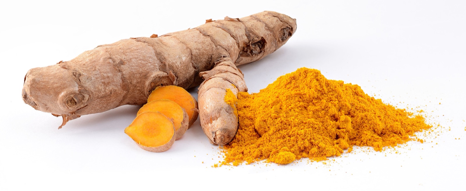 Brown turmeric rhizomes, one cut open to show the bright orange inside, next to a mound of yellow-orange turmeric powder