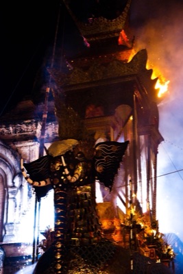 Fireworks and flames at the top of a hatsadiling-bird funeral castle at night