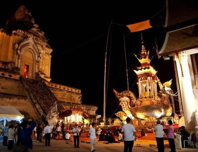 A hatsadiling-bird funeral castle in the grounds of Wat Chedi Luang at night, with people walking around it