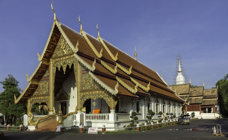 The main vihara of Wat Phra Singh Woramahawihan in Chiang Mai, its gable decorated with gold, with the chedi behind