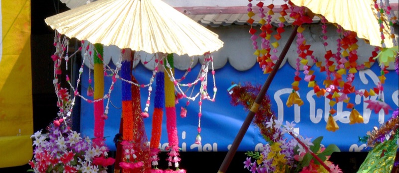 Sang long flower headdresses, a golden umbrella and colourful garlands in a Poy Sang Long procession in Chiang Mai