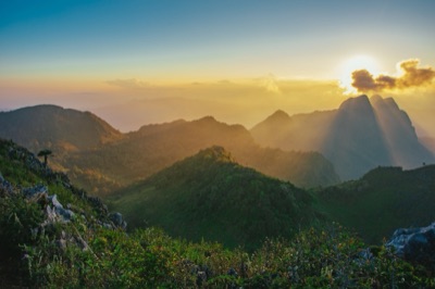 The steep limestone peaks of Doi Luang Chiang Dao under a blue sky