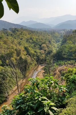 The Fang River winding through green forest in a valley