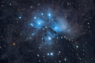The bright blue Pleiades star cluster in the night sky
