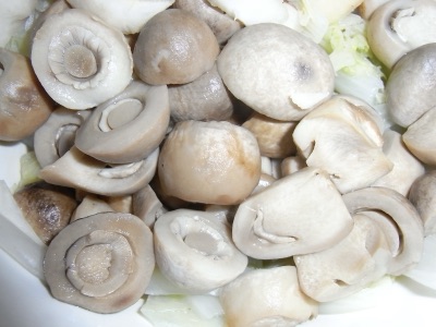 Grey straw mushroom buttons piled together